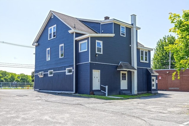 318 Newton St, South Hadley, MA 01075 - view of home's exterior with entry steps and a chimney