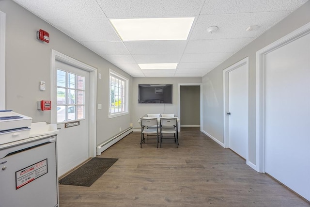 318 Newton St, South Hadley, MA 01075 - dining room with baseboard heating, a drop ceiling, wood finished floors, and baseboards