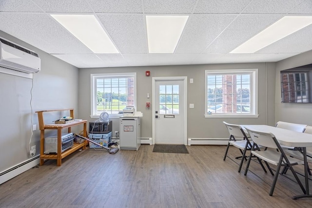 318 Newton St, South Hadley, MA 01075 - interior space with baseboard heating, wood finished floors, healthy amount of natural light, and a drop ceiling