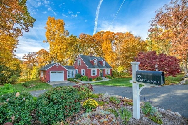 view of front of house with a garage, driveway, and a front lawn