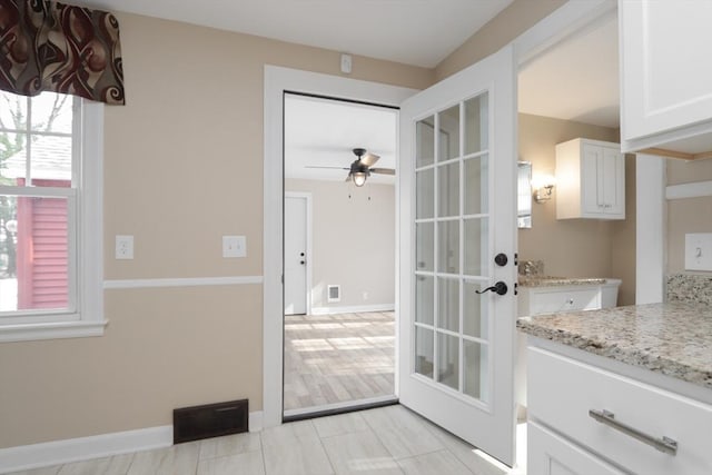 doorway to outside with visible vents, ceiling fan, french doors, and baseboards