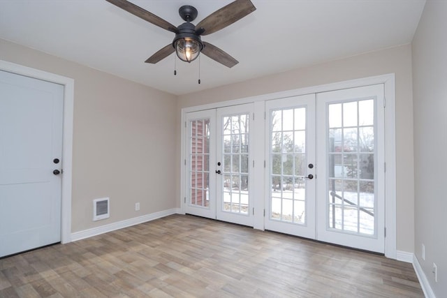 doorway featuring visible vents, french doors, light wood-style floors, and baseboards