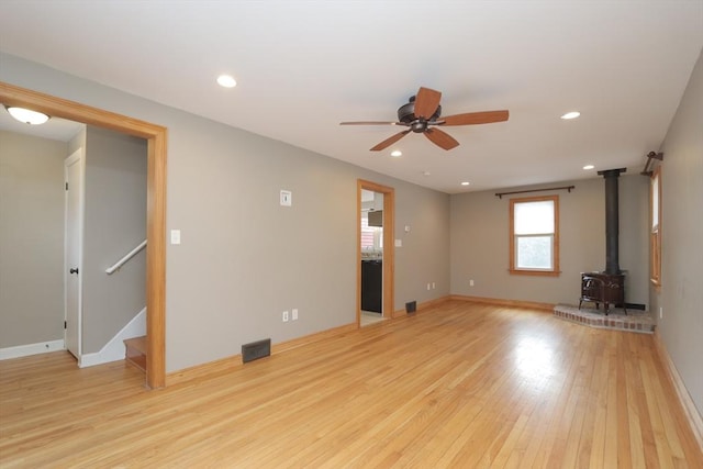 unfurnished living room with recessed lighting, visible vents, light wood-style floors, and stairway