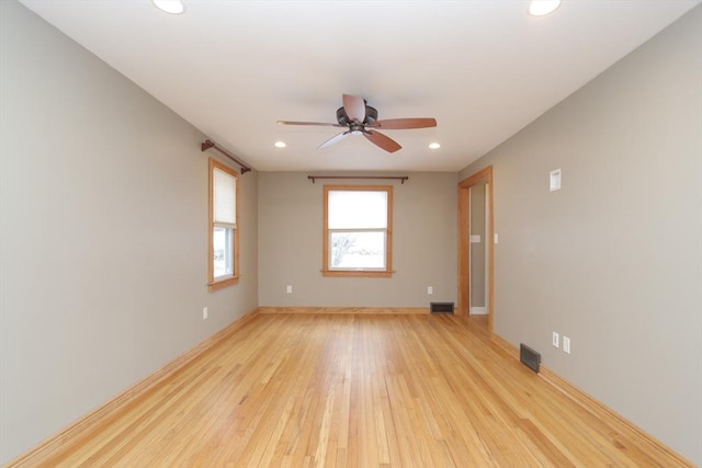 empty room with recessed lighting, light wood-style flooring, baseboards, and visible vents