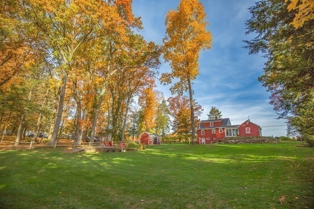 view of yard featuring an outbuilding and a shed