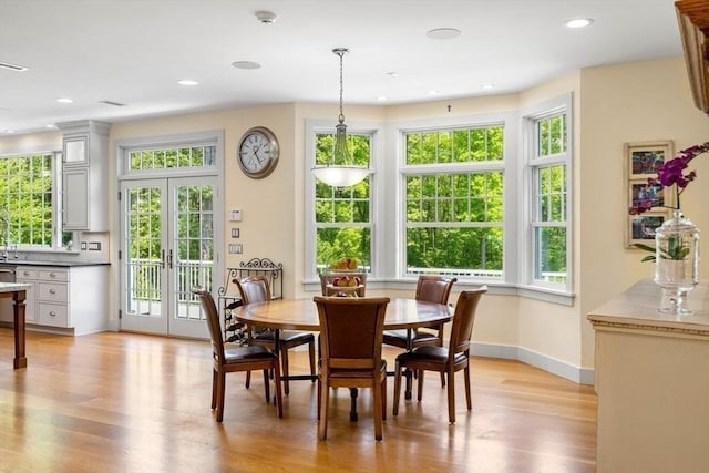 dining space featuring baseboards, recessed lighting, light wood-style floors, and french doors