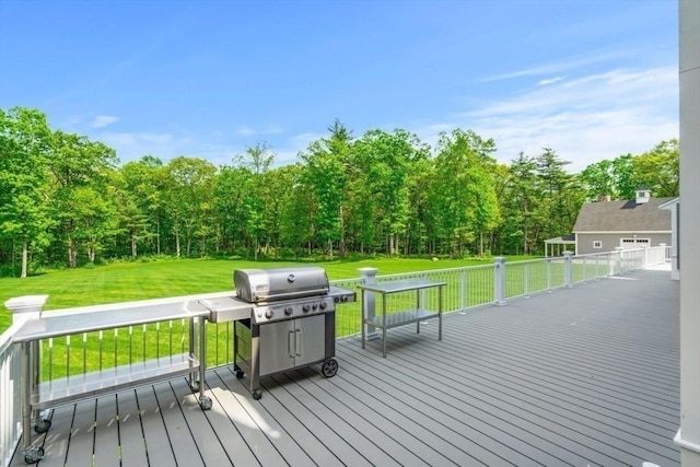 deck with a lawn and grilling area
