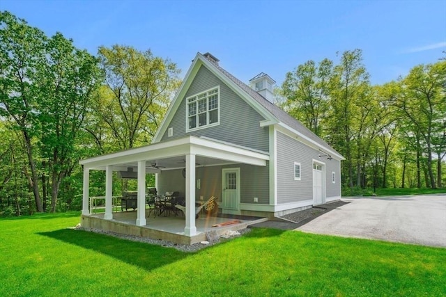 back of house featuring a lawn, a patio area, and ceiling fan