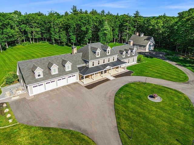 birds eye view of property with a view of trees