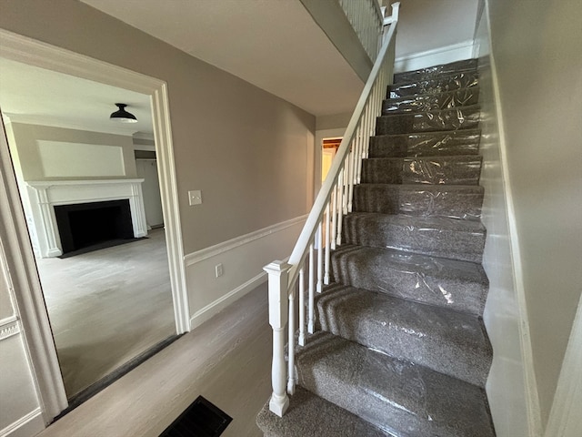 stairway with hardwood / wood-style floors