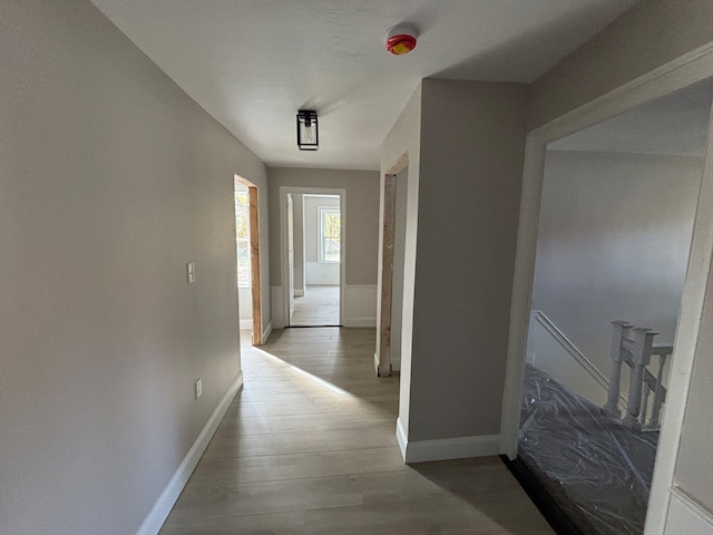 hallway with hardwood / wood-style flooring