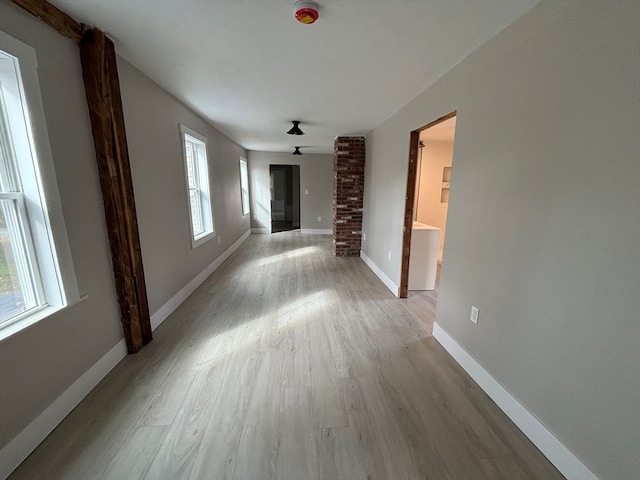 corridor with light hardwood / wood-style floors