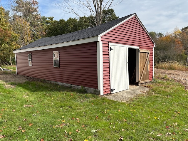 view of outbuilding featuring a lawn