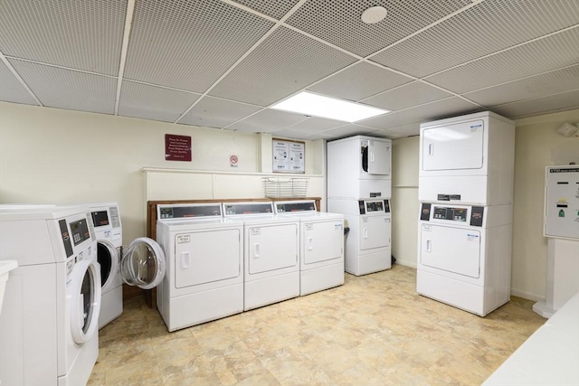 clothes washing area featuring stacked washer and dryer