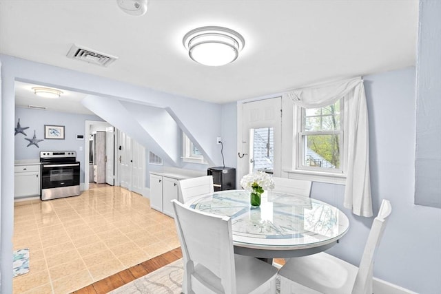dining space with baseboards and visible vents