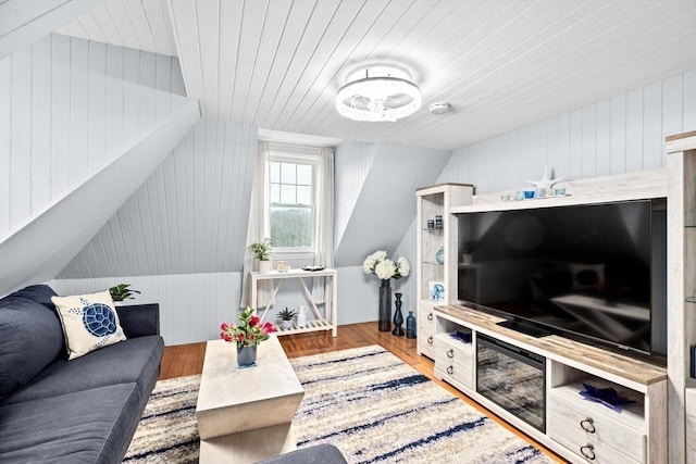 living area featuring wooden ceiling, wood walls, and wood finished floors