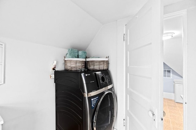 clothes washing area with laundry area, washer / clothes dryer, and visible vents