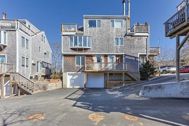 view of front of home featuring driveway, stairway, and an attached garage