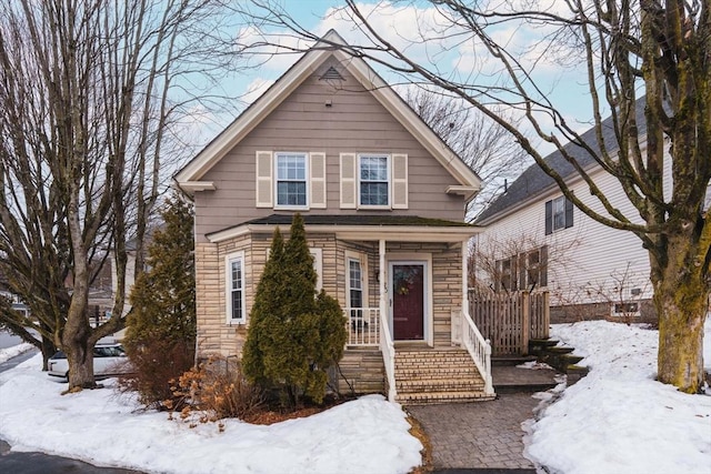 view of front facade featuring stone siding and covered porch