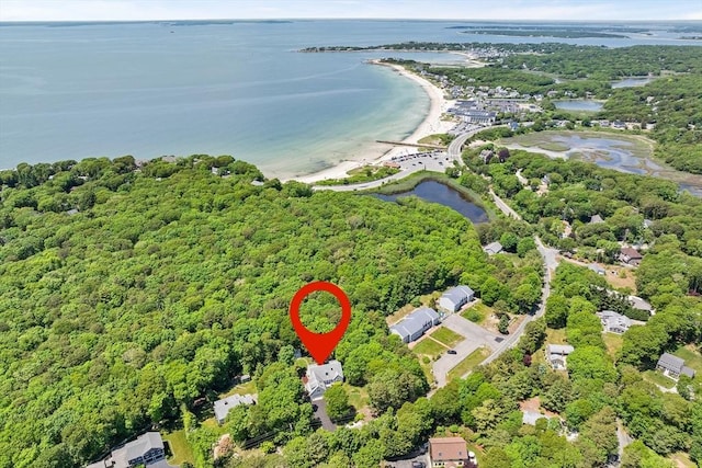 drone / aerial view featuring a water view and a wooded view