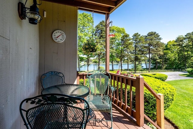 17 Ships Way Unit 17, Bourne, MA 02532 - deck featuring a water view, outdoor dining area, and view of scattered trees