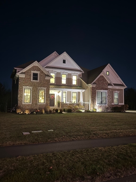 view of front of home with a lawn and a porch