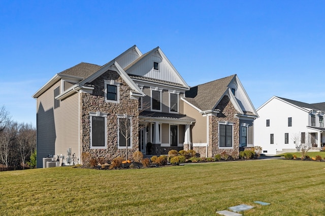 view of front of property featuring a front yard, a porch, and central AC