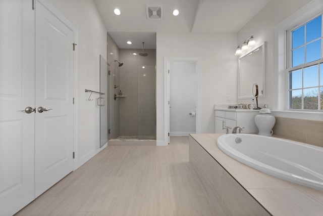 bathroom with separate shower and tub and vanity