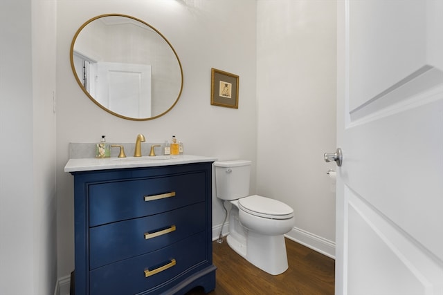 bathroom featuring hardwood / wood-style floors, vanity, and toilet