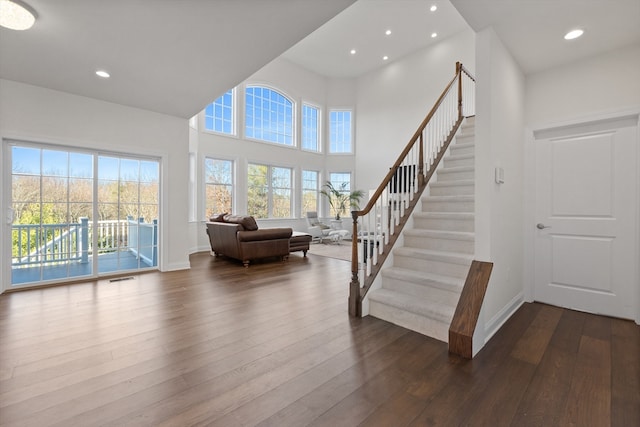 interior space featuring hardwood / wood-style floors and a high ceiling