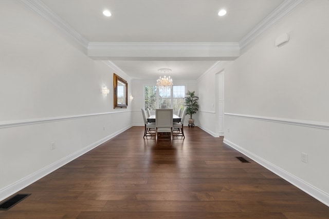 unfurnished dining area with dark hardwood / wood-style flooring, an inviting chandelier, and ornamental molding