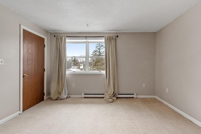 carpeted spare room featuring a baseboard radiator, a textured ceiling, and baseboards