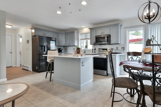 109 Macintosh Ln, Fitchburg, MA 01420 - kitchen featuring a kitchen island, light countertops, appliances with stainless steel finishes, and gray cabinets