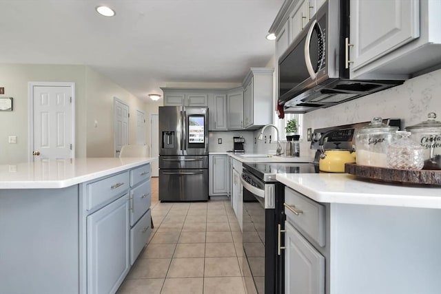 109 Macintosh Ln, Fitchburg, MA 01420 - kitchen with a sink, light countertops, gray cabinets, and appliances with stainless steel finishes