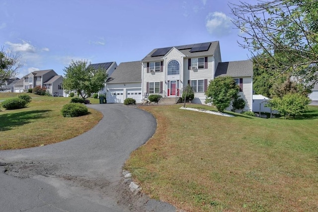 109 Macintosh Ln, Fitchburg, MA 01420 - colonial inspired home with an attached garage, roof mounted solar panels, a residential view, a front yard, and driveway