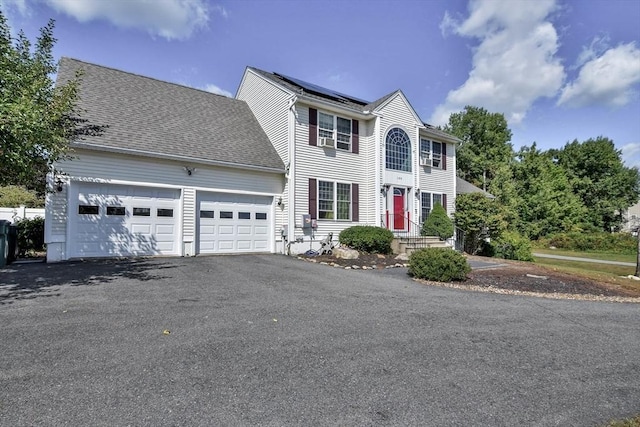 109 Macintosh Ln, Fitchburg, MA 01420 - colonial home with aphalt driveway, a garage, and solar panels