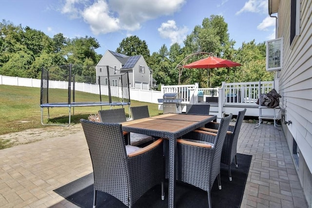 109 Macintosh Ln, Fitchburg, MA 01420 - view of patio featuring fence, a trampoline, a wooden deck, and outdoor dining space