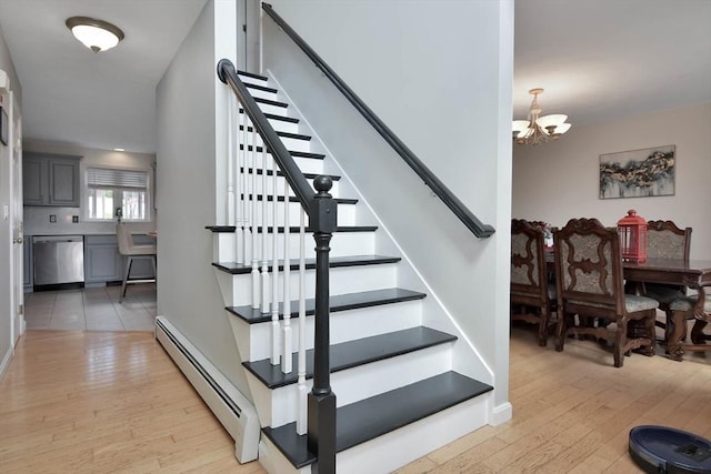 109 Macintosh Ln, Fitchburg, MA 01420 - stairway featuring a chandelier, hardwood / wood-style flooring, baseboards, and baseboard heating