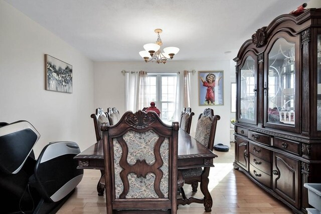 109 Macintosh Ln, Fitchburg, MA 01420 - dining space with a notable chandelier and light wood-type flooring