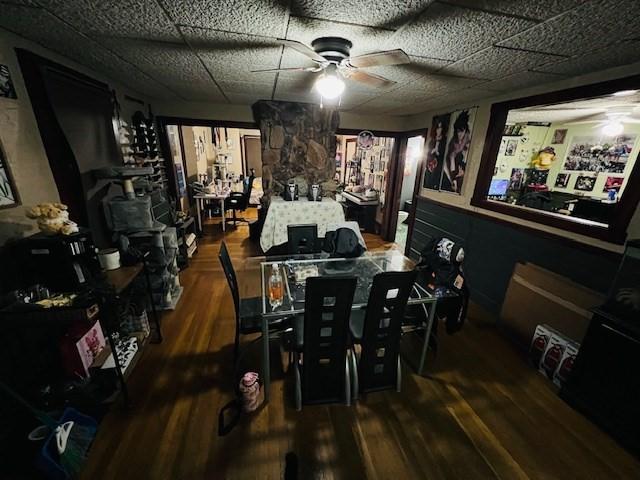 dining room featuring a paneled ceiling, a ceiling fan, and wood finished floors