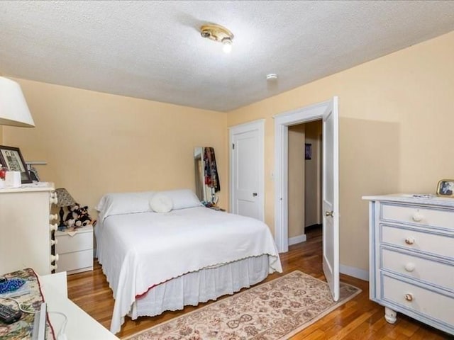 bedroom with hardwood / wood-style floors