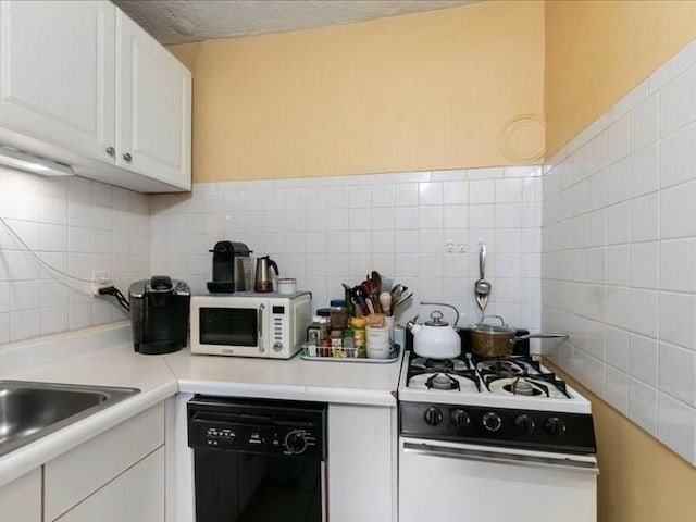 kitchen featuring white appliances and white cabinetry