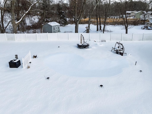 yard covered in snow featuring fence