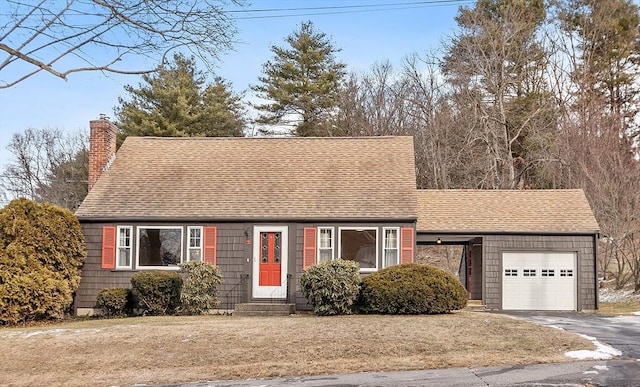 view of front of home featuring a garage and a front lawn