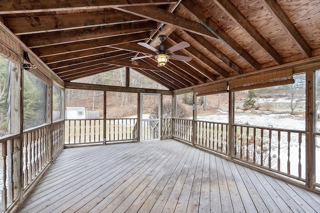 unfurnished sunroom with vaulted ceiling and ceiling fan