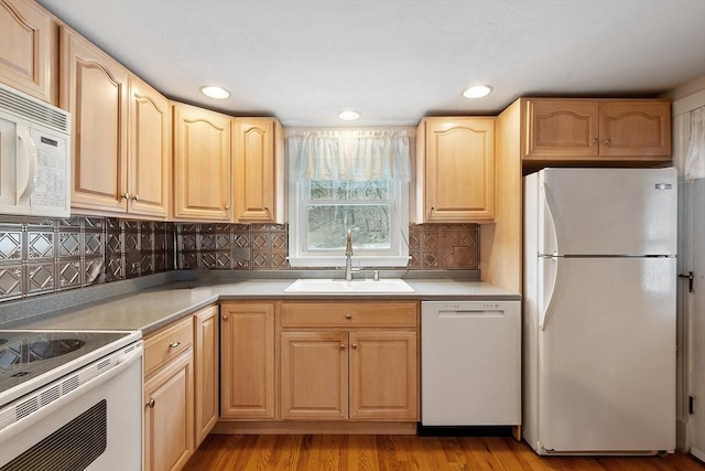 kitchen with sink, white appliances, and light brown cabinetry