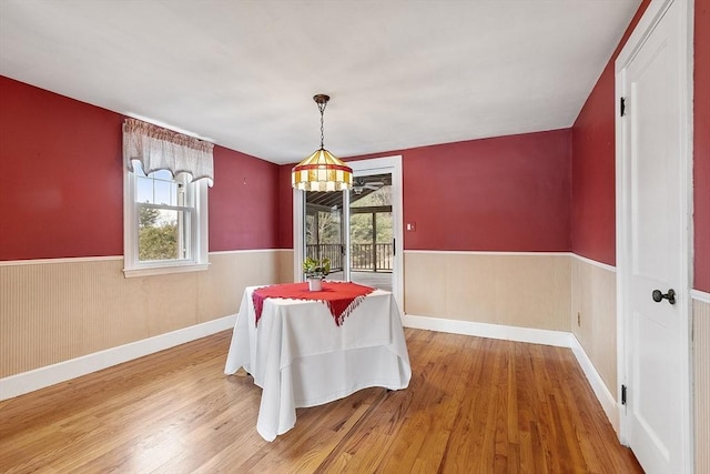 dining space with wood-type flooring