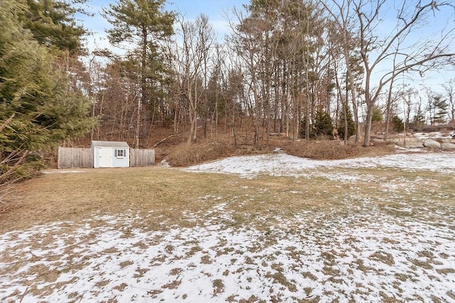 snowy yard with a shed