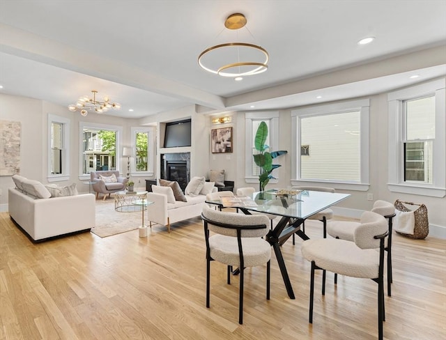 34 Walker St, Somerville, MA 02144 - dining space featuring light wood-type flooring, baseboards, a fireplace, and recessed lighting