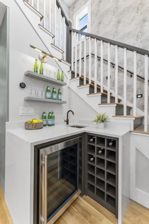 34 Walker St, Somerville, MA 02144 - indoor wet bar featuring beverage cooler, stairs, and light wood finished floors